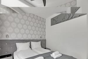 a bedroom with a bed and a wall at Apartament Molo - NoclegiSopot in Sopot
