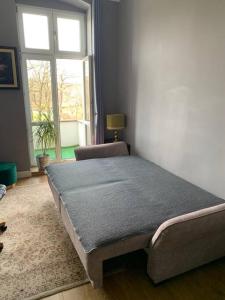 a bed sitting in a room with a window at 3 Bedroom Lux Apartment Center in Wrocław