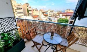 a table and chairs on a balcony with a view at Lamia - Premium apartment in Lamía
