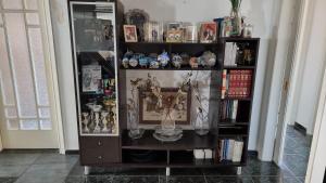 a book shelf filled with lots of items at Lamia - Premium apartment in Lamía