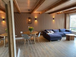 a living room with a blue couch and a table at Seehaus Plön in Plön