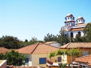 a building with two domes on top of roofs at View-Family Apartment in Moúdhros