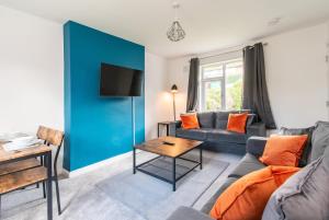 a living room with a couch and a table at Newly Refurbished Homely 4BR in Sherwood in Nottingham