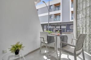 a table and chairs on the balcony of a building at 7even in Corralejo