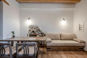 a living room with a table and a couch at Nomas Home Skaloti with Private Pool in Skalotí