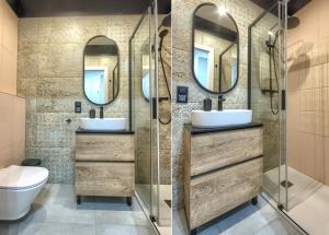 a bathroom with two sinks and two mirrors at Studio Bueno 5.2 - ACCO RENT in Gdańsk
