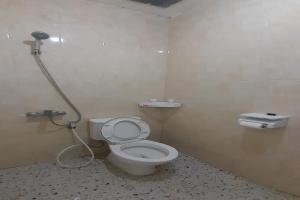 a bathroom with a toilet and a shower at SPOT ON 92481 Modena Homestay Syariah in Medan