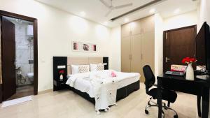 a bedroom with a bed and a desk and a computer at Olive Service Apartments - DLF Cyber City in Gurgaon