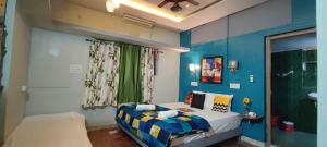 a small bedroom with a bed and a bathroom at Shankar Homestay in Hampi