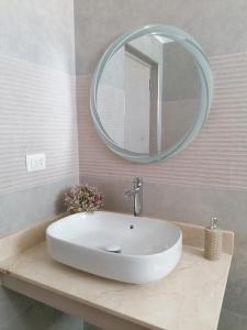 a bathroom with a white sink and a mirror at Caribbean Star - Estrella Dominicus Bayahibe in Bayahibe