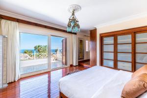 a bedroom with a bed and a view of the ocean at Sharm and Charme at Sheraton Resort in Sharm El Sheikh