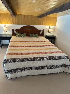 Casa Rural El Pasil في أرونا: غرفة نوم بسرير كبير وطاولتين
