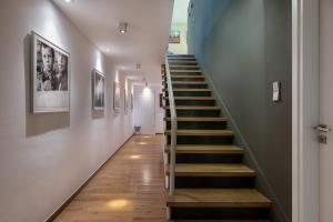 a staircase in a house with blue walls and wooden floors at Villa 7 in Perivólia