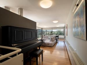 a living room with a piano and a couch at Villa 7 in Perivólia