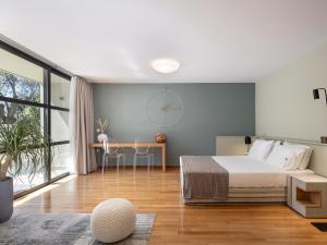 a bedroom with a bed and a large window at Villa 7 in Perivólia