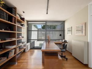 an office with a wooden desk and a large window at Villa 7 in Perivólia