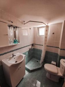 a bathroom with a sink and a toilet and a shower at La mer in Moúdhros +12 photos