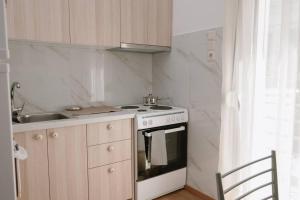 a small kitchen with a stove and a sink at Luxury apartment, in Heraklion in Heraklio