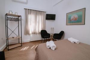 a bedroom with a bed with two towels on it at Luxury apartment, in Heraklion in Heraklio
