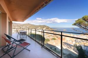 a balcony with chairs and a view of the ocean at Pool and sea views apartment with 1 parking space in Tossa de Mar