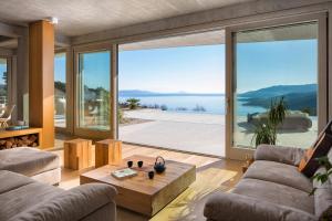 a living room with a view of the water at Green Tree Villas in Rabac