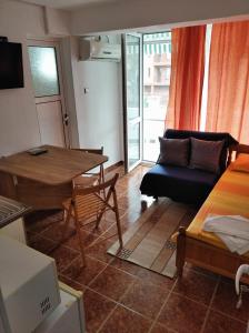 a living room with a couch and a table at Guesthouse Kolevi in Lozenets