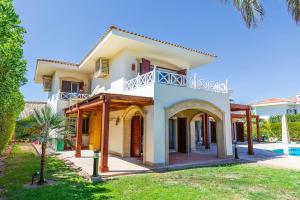 a large white house with a swimming pool at Sharm and Charme at Sheraton Resort in Sharm El Sheikh