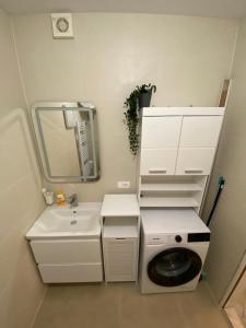 a small bathroom with a sink and a toilet at Cosy, sea view apartment Porat in Porat
