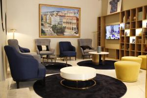 a waiting room with chairs and a table at Golden Tulip Opera Alger in Ouled Fayet