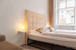 a bedroom with a bed with a large window at 2 Pleasant Flats - Perfect for Long Stays in Vienna