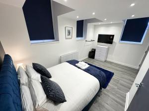 a bedroom with a bed with pillows and a television at Regent Docks-Free Parking in Liverpool