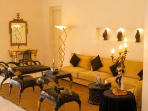 a living room with a couch and chairs and a table at Villa Le Petit Paradis Saly Boutique Hotel in Ngaparou