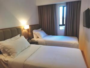 Postel nebo postele na pokoji v ubytování D Loft Hotel