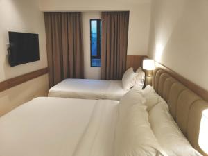 Postel nebo postele na pokoji v ubytování D Loft Hotel