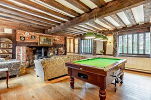 a living room with a pool table in it at Beautiful 10 Bed Oak beamed Country House in Tibenham