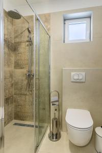 a bathroom with a toilet and a glass shower at BLUE SKY in Cres +11 photos
