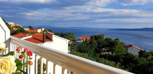 a view of the ocean from a balcony at Villa Nikola - Rina in Brela