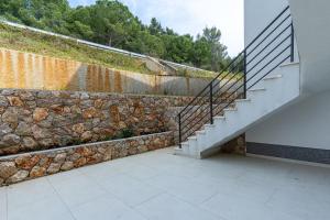 a stone wall and stairs in a house at BLUE SKY in Cres