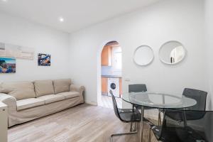 a living room with a couch and a glass table at Two bedroom flat in PobleNou in Barcelona