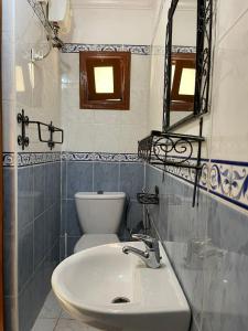 a bathroom with a sink and a toilet at Riad NEJJARINE in Marrakesh