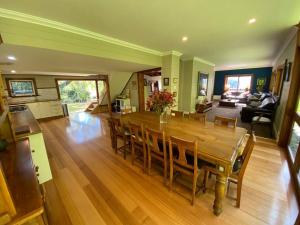 a dining room and living room with a table and chairs at The Barn, Bowral in Bowral