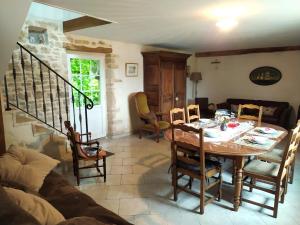 a dining room with a wooden table and chairs at Gîte La Bourgetterie Fontenay sur Mer in Fontenay-sur-Mer +34 photos