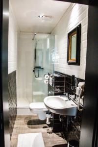 a bathroom with a sink and a toilet and a shower at Hotel Industrie in Leuven +96 photos