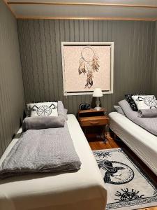 a bedroom with two beds and a picture on the wall at Vörðufell Country Cabin in Selfoss