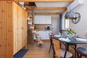 a kitchen and dining room with a table and chairs at Marina & Amber Grzybowo Apartments with Garden by Renters in Grzybowo