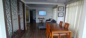 a dining room and living room with a table and chairs at Apartamento Fresco con Terraza-tipo loft in Alto de Garzón