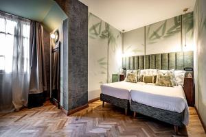 Postel nebo postele na pokoji v ubytování Hotel Duomo Firenze