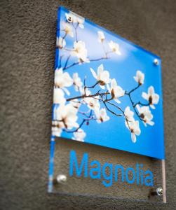 a sign with a magnolia tree on a wall at Apartment Magnolia in Karlstadt