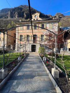 a building with a walkway in front of it at B&B VILLA ROSA in Anzino