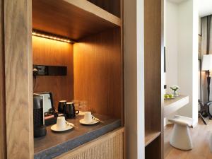 a kitchen with a counter with two dishes on it at Leonardo Boutique Hotel Larnaca in Larnaca